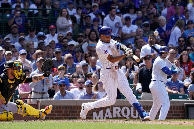 May 19, 2024; Chicago, Illinois, USA; Chicago Cubs third baseman Christopher Morel (5) hits a RBI sacrifice against the Pittsburgh Pirates during the sixth inning at Wrigley Field. Mandatory Credit: David Banks-USA TODAY Sports