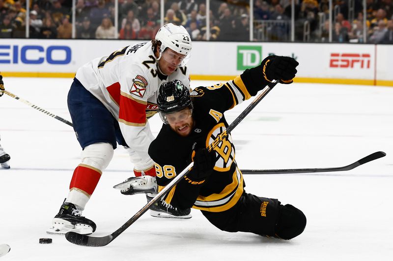 Oct 21, 2025; Boston, Massachusetts, USA; Boston Bruins right wing David Pastrnak (88) gets off a pass while being taken down by Florida Panthers center Carter Verhaeghe (23) during the third period at TD Garden. Mandatory Credit: Winslow Townson-Imagn Images