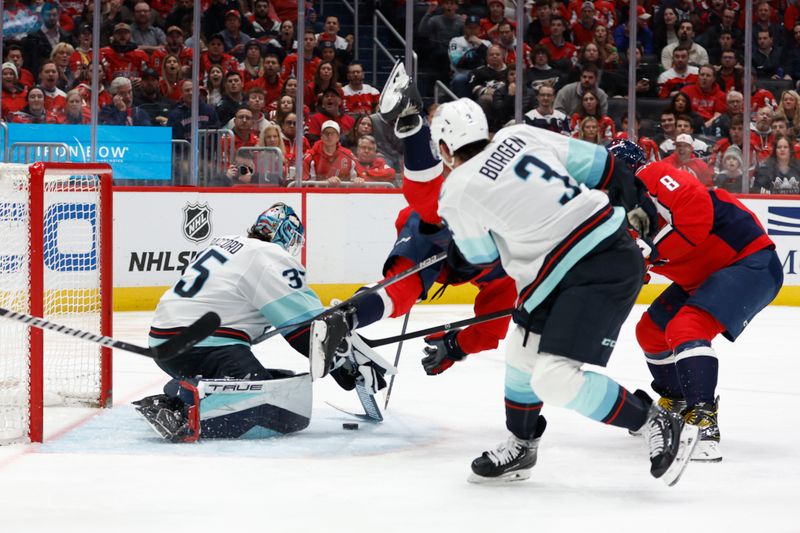 Jan 11, 2024; Washington, District of Columbia, USA; Seattle Kraken goaltender Joey Daccord (35) makes a save on Washington Capitals defenseman Nick Jensen (3) as Kraken defenseman Will Borgen (3) defends in the third period at Capital One Arena. Mandatory Credit: Geoff Burke-USA TODAY Sports