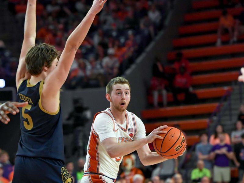 Feb 26, 2025; Clemson, South Carolina, USA; Clemson guard Jake Heidbreder (3) passes the ball near Notre Dame guard Cole Certa (5) during the second half at Littlejohn Coliseum. Mandatory Credit: Ken Ruinard-Imagn Images