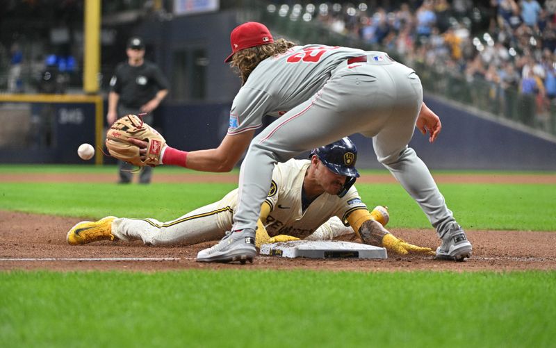 Sep 16, 2024; Milwaukee, Wisconsin, USA; Milwaukee Brewers third base Joey Ortiz (3) slides safely into third base for a triple ahead of the tag by Philadelphia Phillies third base Alec Bohm (28) in the sixth inning at American Family Field. Mandatory Credit: Michael McLoone-Imagn Images