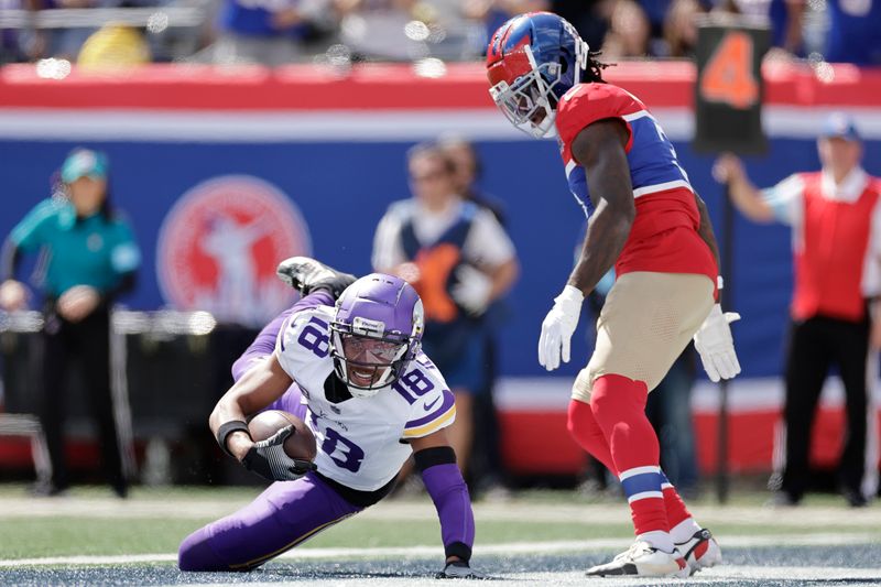 Minnesota Vikings wide receiver Justin Jefferson (18) scores a 3-yard touchdown against New York Giants cornerback Deonte Banks (3), right, during the first half of an NFL football game, Sunday, Sept. 8, 2024, in East Rutherford, N.J. (AP Photo/Adam Hunger)