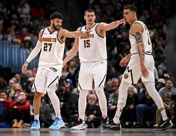 DENVER, CO - DECEMBER 25: Jamal Murray (27) and Nikola Jokic (15) of the Denver Nuggets direct teammate Michael Porter Jr. (1) where to be on defenses against the Golden State Warriors during the fourth quarter of the Nuggets' 120-114 win at Ball Arena in Denver on Monday, December 25, 2023. (Photo by AAron Ontiveroz/The Denver Post)