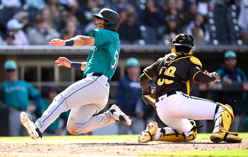 Mar 26, 2024; San Diego, California, USA; Seattle Mariners catcher Jake Anchia (56) scores a run past San Diego Padres catcher Ethan Salas (88) during the ninth inning at Petco Park. Mandatory Credit: Orlando Ramirez-USA TODAY Sports