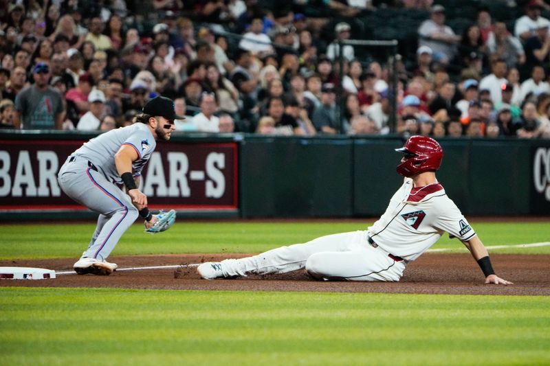 Jun 28, 2025; Phoenix, Arizona, USA; Arizona Diamondbacks outfielder Randal Grichuk (15) slides safely into third base in the fourth inning against the Miami Marlins at Chase Field. Mandatory Credit: Arianna Grainey-Imagn Images
