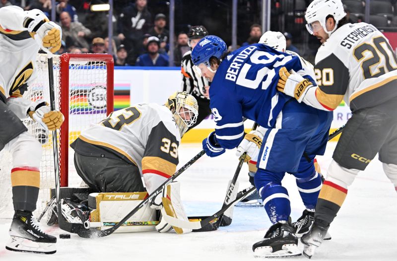 Feb 27, 2024; Toronto, Ontario, CAN;  Vegas Golden Knights goalie Adin Hill (33) makes a save on a scoring attempt by Toronto Maple Leafs forward Tyler Bertuzzi (59) in the third  period at Scotiabank Arena. Mandatory Credit: Dan Hamilton-USA TODAY Sports