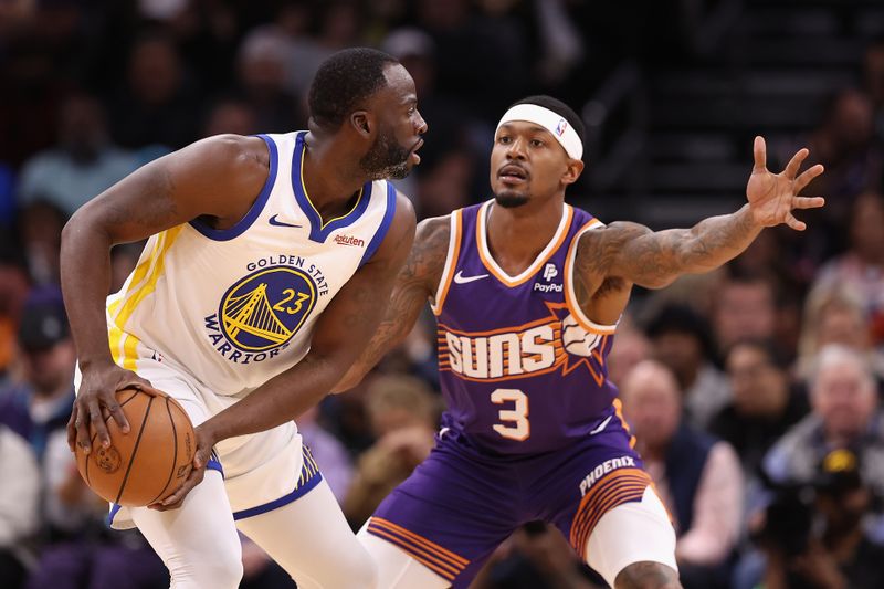 PHOENIX, ARIZONA - DECEMBER 12: Draymond Green #23 of the Golden State Warriors looks to pass around Bradley Beal #3 of the Phoenix Suns during the first half of the NBA game at Footprint Center on December 12, 2023 in Phoenix, Arizona. NOTE TO USER: User expressly acknowledges and agrees that, by downloading and or using this photograph, User is consenting to the terms and conditions of the Getty Images License Agreement.  (Photo by Christian Petersen/Getty Images)