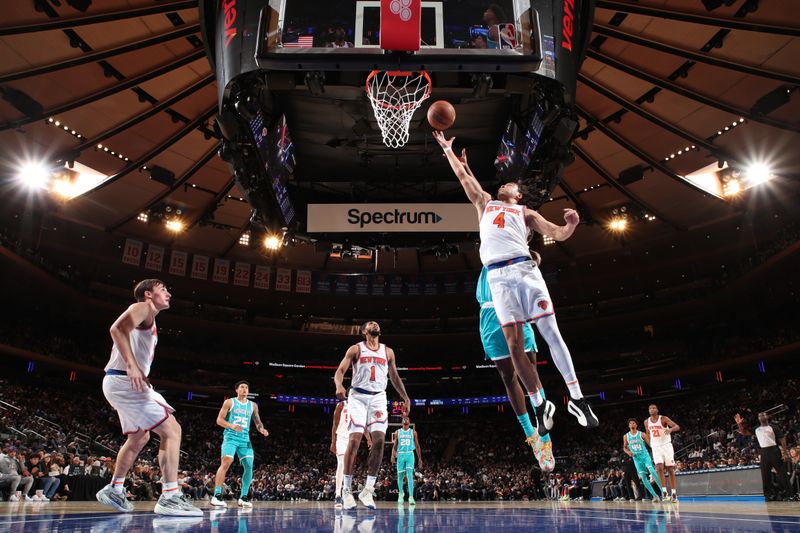 NEW YORK, NY - OCTOBER 15: Pacome Dadiet #4 of the New York Knicks drives to the basket during the game against the Charlotte Hornets during the 2024 NBA Preseason on October 15, 2024 at Madison Square Garden in New York City, New York.  NOTE TO USER: User expressly acknowledges and agrees that, by downloading and or using this photograph, User is consenting to the terms and conditions of the Getty Images License Agreement. Mandatory Copyright Notice: Copyright 2024 NBAE  (Photo by Nathaniel S. Butler/NBAE via Getty Images)