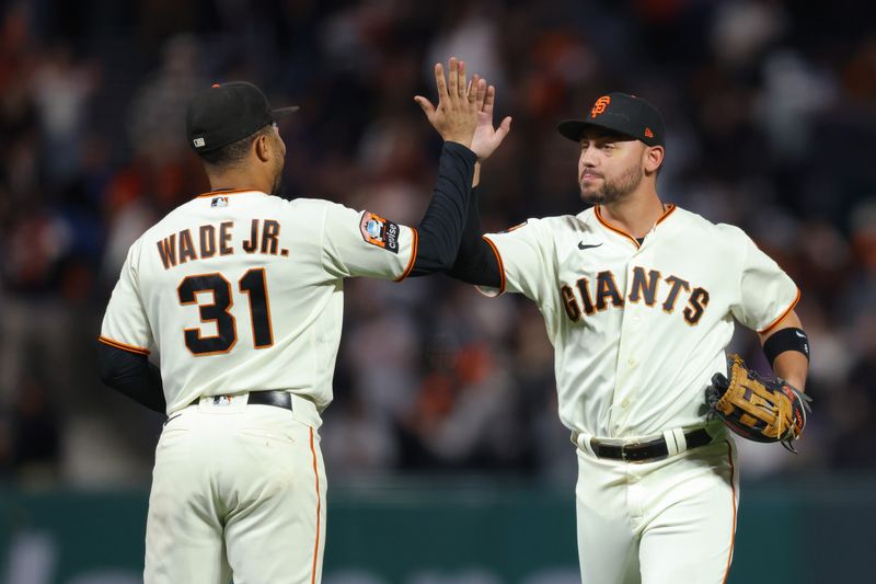 Sep 25, 2023; San Francisco, California, USA; San Francisco Giants right fielder Michael Conforto (8) and first baseman LaMonte Wade Jr. (31) celebrate their win after the game against the San Diego Padres at Oracle Park. Mandatory Credit: Sergio Estrada-USA TODAY Sports