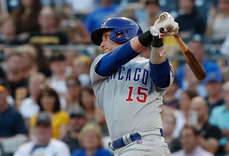 Aug 24, 2023; Pittsburgh, Pennsylvania, USA; Chicago Cubs catcher Yan Gomes (15) hits a single against the Pittsburgh Pirates/ during the second inning at PNC Park. Mandatory Credit: Charles LeClaire-USA TODAY Sports