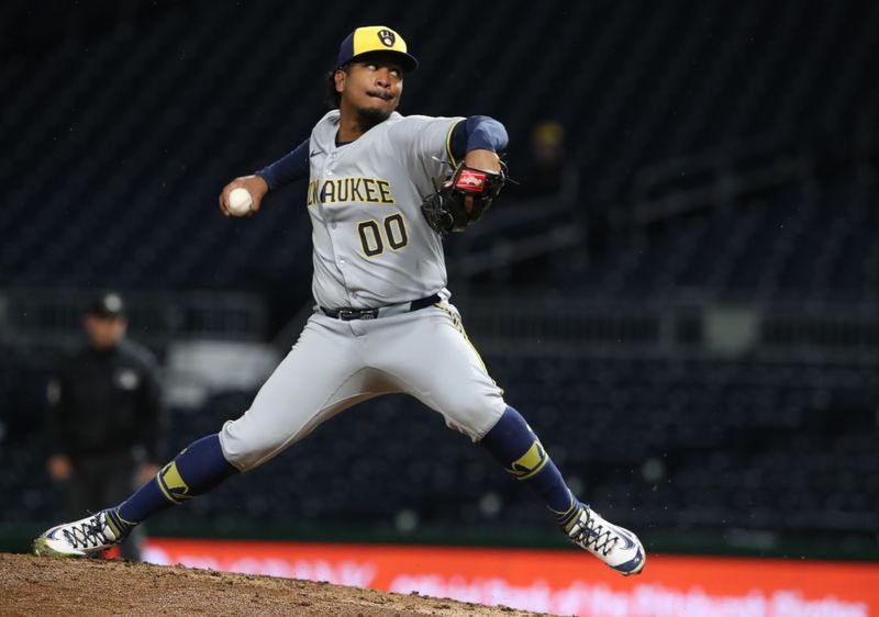May 22, 2025; Pittsburgh, Pennsylvania, USA;  Milwaukee Brewers relief pitcher  Carlos Rodriguez (00) pitches against the Pittsburgh Pirates during the ninth inning at PNC Park. Mandatory Credit: Charles LeClaire-Imagn Images