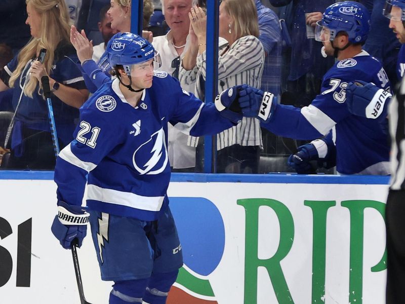 Oct 15, 2024; Tampa, Florida, USA;Tampa Bay Lightning center Brayden Point (21) is congratulated after he scored a goal against the Vancouver Canucks  during the second period at Amalie Arena. Mandatory Credit: Kim Klement Neitzel-Imagn Images