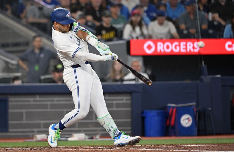 Jun 4, 2025; Toronto, Ontario, CAN;  Toronto Blue Jays shortstop Bo Bichette (11) hits a double against the Philadelphia Phillies in the sixth inning at Rogers Centre. Mandatory Credit: Dan Hamilton-Imagn Images