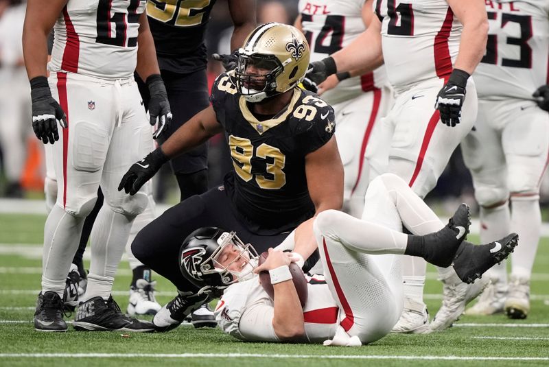 Atlanta Falcons quarterback Logan Woodside (11) is sacked by New Orleans Saints defensive tackle Nathan Shepherd (93) in the second half of an NFL football game in New Orleans, Sunday, Jan. 7, 2024. (AP Photo/Gerald Herbert)