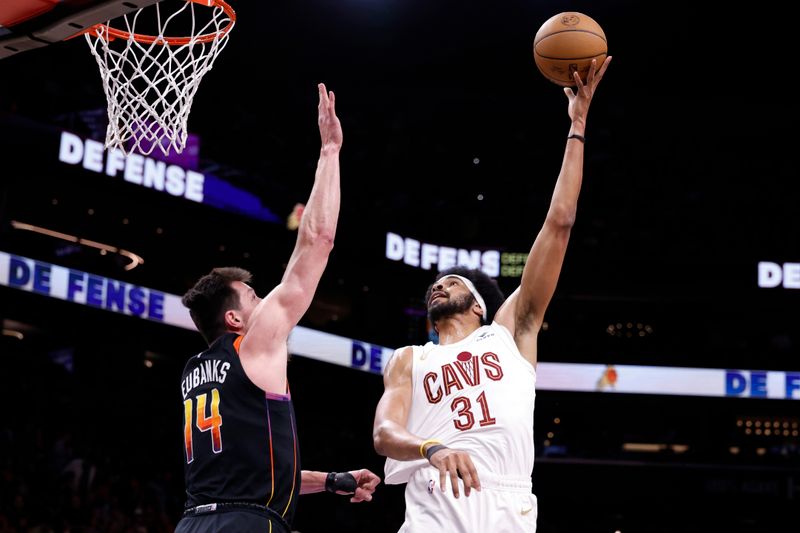 PHOENIX, ARIZONA - APRIL 03: Jarrett Allen #31 of the Cleveland Cavaliers attempts a shot against Drew Eubanks #14 of the Phoenix Suns during the first half at Footprint Center on April 03, 2024 in Phoenix, Arizona. NOTE TO USER: User expressly acknowledges and agrees that, by downloading and or using this photograph, User is consenting to the terms and conditions of the Getty Images License Agreement.  (Photo by Chris Coduto/Getty Images)