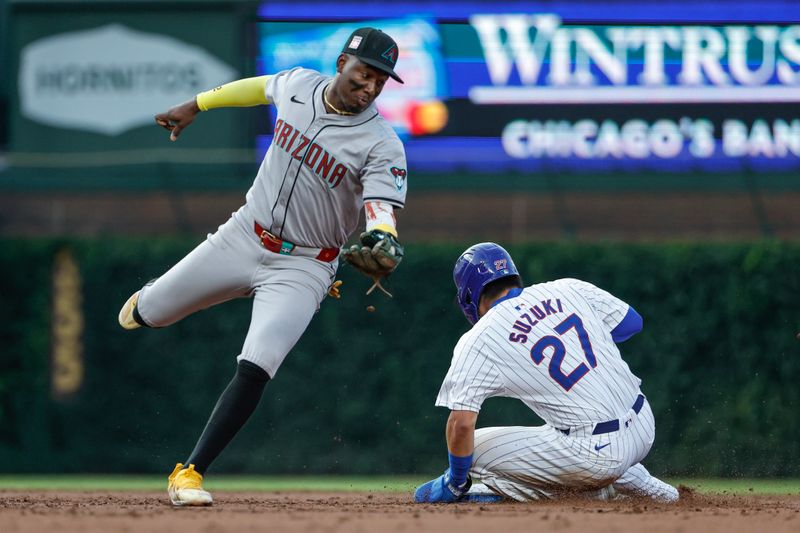 Jul 20, 2024; Chicago, Illinois, USA; Chicago Cubs outfielder Seiya Suzuki (27) steals second base against Arizona Diamondbacks shortstop Geraldo Perdomo (2) during the third inning at Wrigley Field. Mandatory Credit: Kamil Krzaczynski-USA TODAY Sports