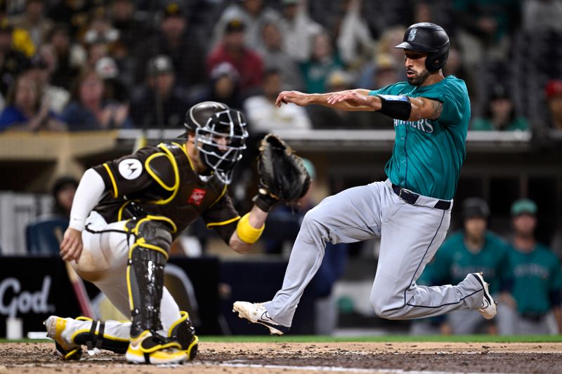 Mar 25, 2024; San Diego, California, USA; Seattle Mariners catcher Seby Zavala (right) scores a run ahead of the throw to San Diego Padres catcher Brett Sullivan (left) during the ninth inning at Petco Park. Mandatory Credit: Orlando Ramirez-USA TODAY Sports