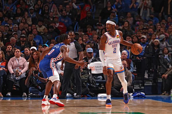 OKLAHOMA CITY, OK - NOVEMBER 25:  Shai Gilgeous-Alexander #2 of the Oklahoma City Thunder handles the ball during the game against the Philadelphia 76ers on November 25, 2023 at Paycom Arena in Oklahoma City, Oklahoma. NOTE TO USER: User expressly acknowledges and agrees that, by downloading and or using this photograph, User is consenting to the terms and conditions of the Getty Images License Agreement. Mandatory Copyright Notice: Copyright 2023 NBAE (Photo by Zach Beeker/NBAE via Getty Images)