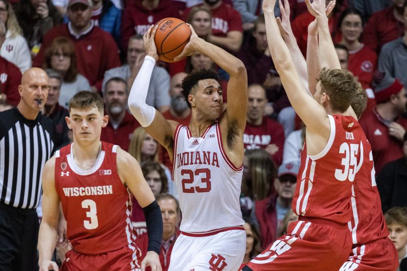 Jan 14, 2023; Bloomington, Indiana, USA; Indiana Hoosiers forward Trayce Jackson-Davis (23) passes the ball while Wisconsin Badgers forward Markus Ilver (35) defends in the second half at Simon Skjodt Assembly Hall. Mandatory Credit: Trevor Ruszkowski-USA TODAY Sports