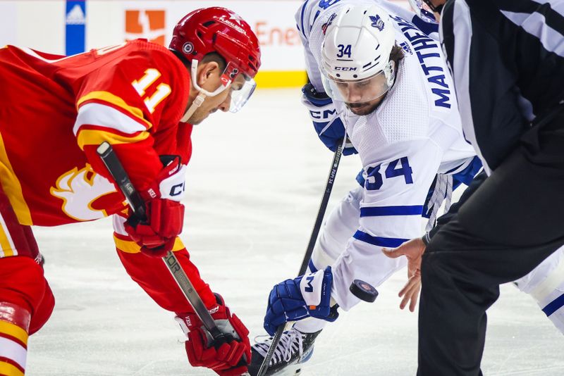 Jan 18, 2024; Calgary, Alberta, CAN; Calgary Flames center Mikael Backlund (11) and Toronto Maple Leafs center Auston Matthews (34) face off for the puck during the first period at Scotiabank Saddledome. Mandatory Credit: Sergei Belski-USA TODAY Sports