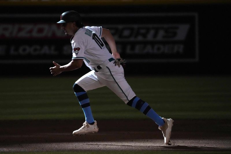 Jun 18, 2023; Phoenix, Arizona, USA; Arizona Diamondbacks relief pitcher Josh Rojas (10) runs to third base against the Cleveland Guardians during the ninth inning at Chase Field. Mandatory Credit: Joe Camporeale-USA TODAY Sports