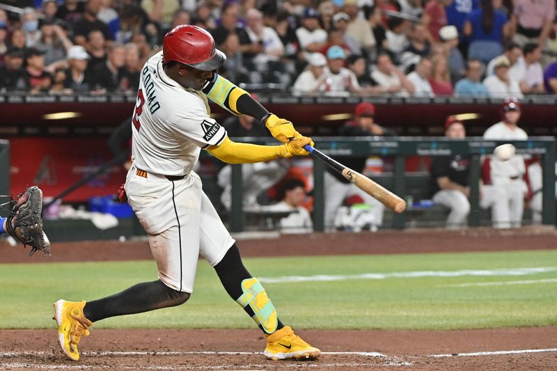 May 8, 2025; Phoenix, Arizona, USA; Arizona Diamondbacks shortstop Geraldo Perdomo (2) doubles in the seventh inning against the Los Angeles Dodgers at Chase Field. Mandatory Credit: Matt Kartozian-Imagn Images