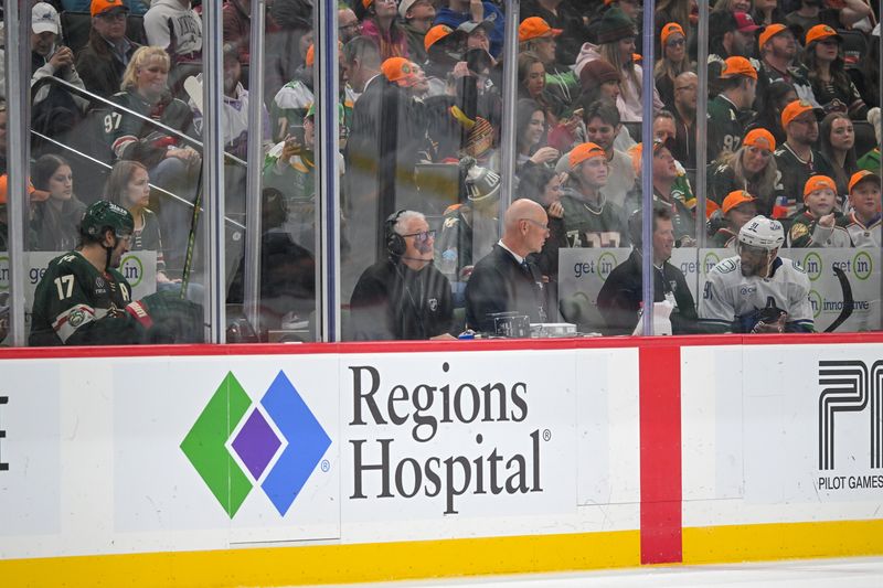 Nov 1, 2025; Saint Paul, Minnesota, USA;  Minnesota Wild forward Marcus Foligno (17) and Vancouver Canucks forward Evander Kane (91) talk to each other while in their respective penalty boxes during the third period at Grand Casino Arena. Mandatory Credit: Nick Wosika-Imagn Images