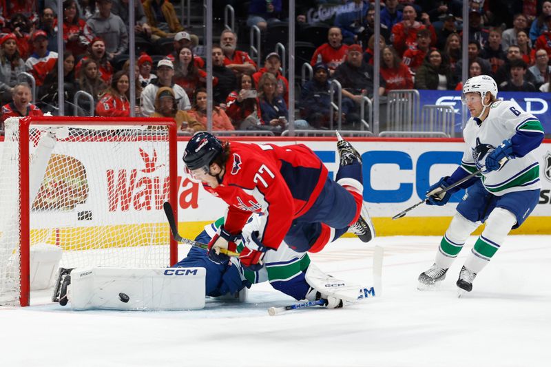 Feb 11, 2024; Washington, District of Columbia, USA; Washington Capitals right wing T.J. Oshie (77) shoots the puck on Vancouver Canucks goaltender Thatcher Demko (35) in the first period at Capital One Arena. Mandatory Credit: Geoff Burke-USA TODAY Sports