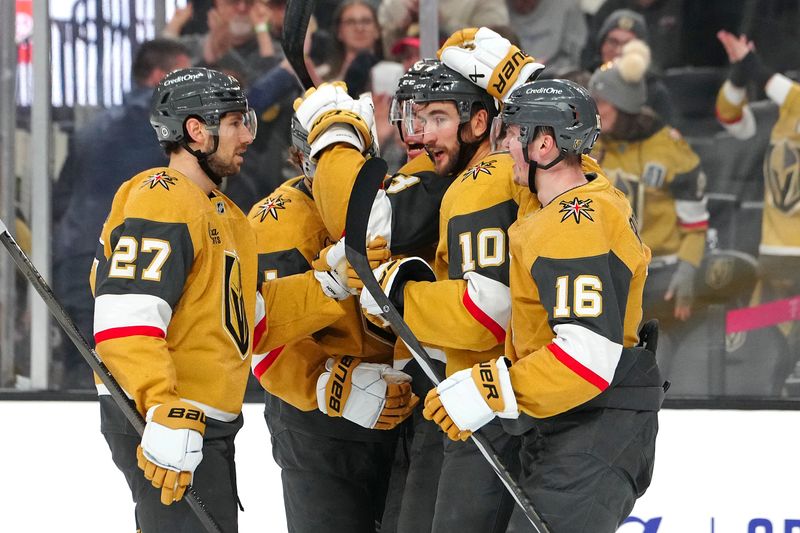 Dec 6, 2024; Las Vegas, Nevada, USA; Vegas Golden Knights center Nicolas Roy (10) celebrates with Vegas Golden Knights defenseman Shea Theodore (27) and Vegas Golden Knights left wing Pavel Dorofeyev (16) after scoring a goal against the Dallas Stars during the second period at T-Mobile Arena. Mandatory Credit: Stephen R. Sylvanie-Imagn Images