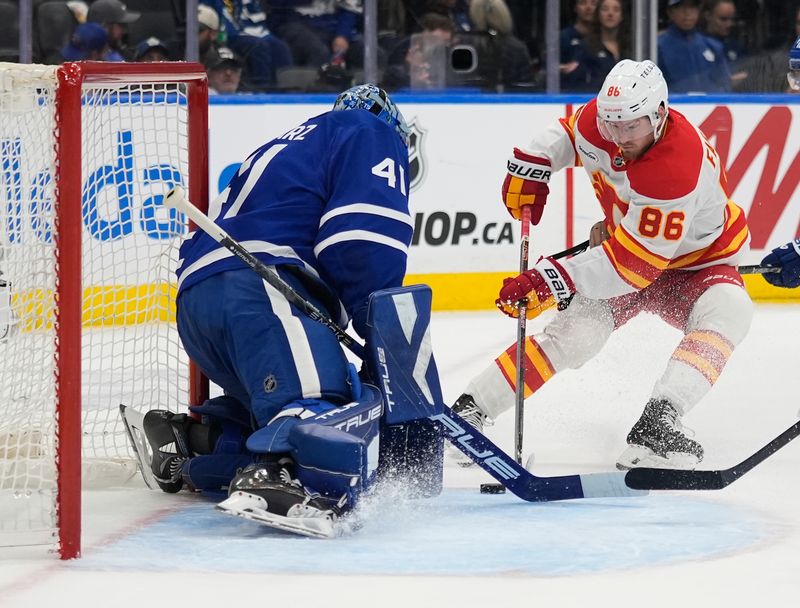 Oct 28, 2025; Toronto, Ontario, CAN; Calgary Flames forward Joel Farabee (86) scores on Toronto Maple Leafs goaltender Anthony Stolarz (41) during the second period at Scotiabank Arena. Mandatory Credit: John E. Sokolowski-Imagn Images
