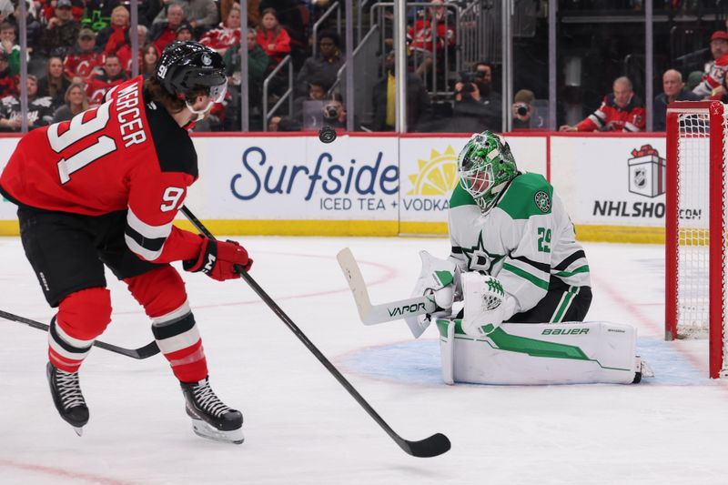 Dec 3, 2025; Newark, New Jersey, USA; Dallas Stars goaltender Jake Oettinger (29) makes a save on New Jersey Devils center Dawson Mercer (91) during the second period at Prudential Center. Mandatory Credit: Ed Mulholland-Imagn Images