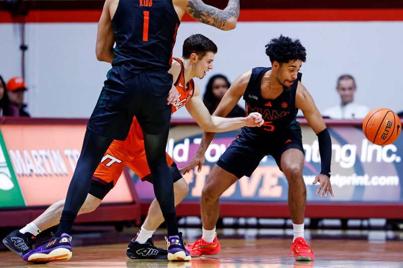 Jan 4, 2025; Blacksburg, Virginia, USA; Virginia Tech Hokies guard Brandon Rechsteiner (7) and Miami Hurricanes guard Jalen Blackmon (5) go for the ball during the second half at Cassell Coliseum. Mandatory Credit: Peter Casey-Imagn Images