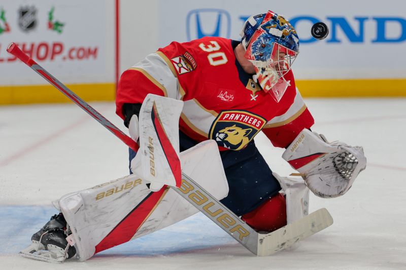 Nov 30, 2024; Sunrise, Florida, USA; Florida Panthers goaltender Spencer Knight (30) makes a save against Carolina Hurricanes center Martin Necas (not pictured) during the first period at Amerant Bank Arena. Mandatory Credit: Sam Navarro-Imagn Images