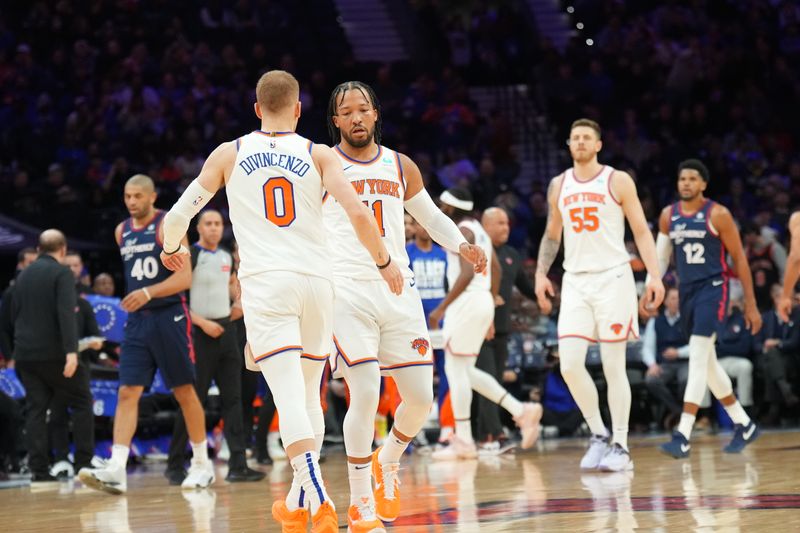 PHILADELPHIA, PA - FEBRUARY 22: Jalen Brunson #11 high fives Donte Divincenzo #0 of the New York Knicks during the game against the Philadelphia 76ers on February 22, 2024 at the Wells Fargo Center in Philadelphia, Pennsylvania NOTE TO USER: User expressly acknowledges and agrees that, by downloading and/or using this Photograph, user is consenting to the terms and conditions of the Getty Images License Agreement. Mandatory Copyright Notice: Copyright 2024 NBAE (Photo by Jesse D. Garrabrant/NBAE via Getty Images)