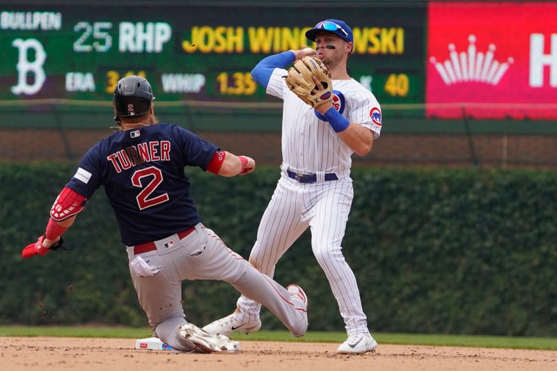 Jul 16, 2023; Chicago, Illinois, USA; Chicago Cubs shortstop Nico Hoerner (2) forces out Boston Red Sox first baseman Justin Turner (2) at second base during the seventh inning at Wrigley Field. Mandatory Credit: David Banks-USA TODAY Sports