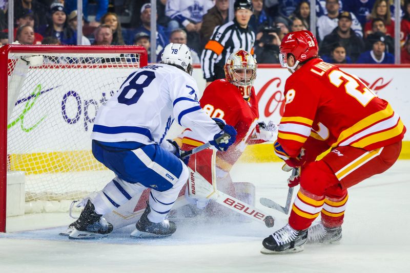Jan 18, 2024; Calgary, Alberta, CAN; Calgary Flames goaltender Dan Vladar (80) makes a save against Toronto Maple Leafs defenseman TJ Brodie (78) during the third period at Scotiabank Saddledome. Mandatory Credit: Sergei Belski-USA TODAY Sports
