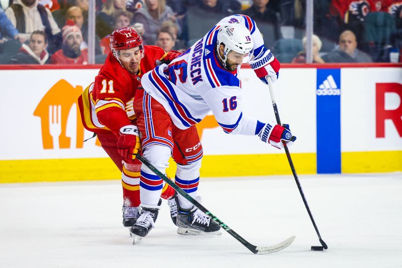 Oct 24, 2023; Calgary, Alberta, CAN; New York Rangers center Vincent Trocheck (16) and Calgary Flames center Mikael Backlund (11) battle for the puck during the first period at Scotiabank Saddledome. Mandatory Credit: Sergei Belski-USA TODAY Sports