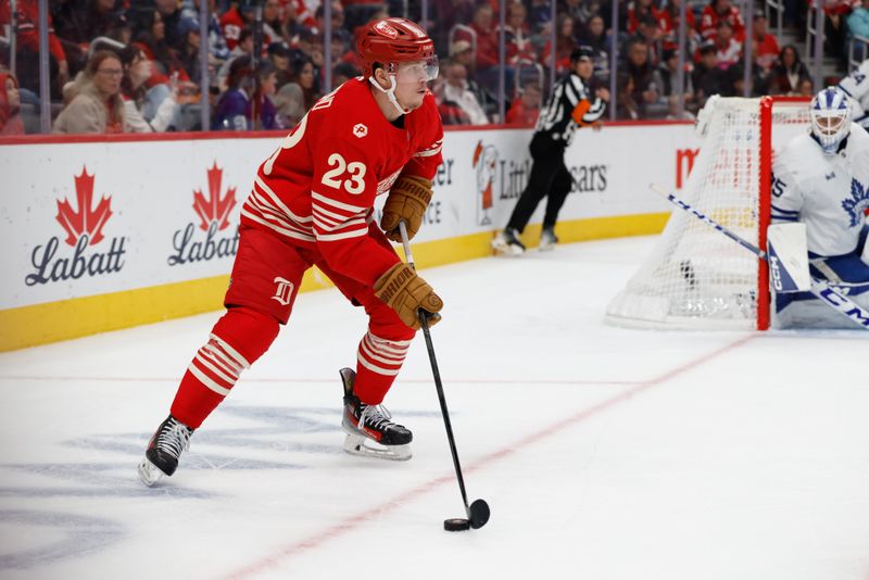 Dec 28, 2025; Detroit, Michigan, USA;  Detroit Red Wings left wing Lucas Raymond (23) skates with the puck in the second period against the Toronto Maple Leafs at Little Caesars Arena. Mandatory Credit: Rick Osentoski-Imagn Images