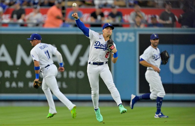 Aug 16, 2023; Los Angeles, California, USA;  Los Angeles Dodgers shortstop Enrique Hernandez (8) makes an out off a fly ball hit by Milwaukee Brewers outfielder Sal Frelick (10) and throws to first to try and pick off the runner in the second inning at Dodger Stadium. Mandatory Credit: Jayne Kamin-Oncea-USA TODAY Sports