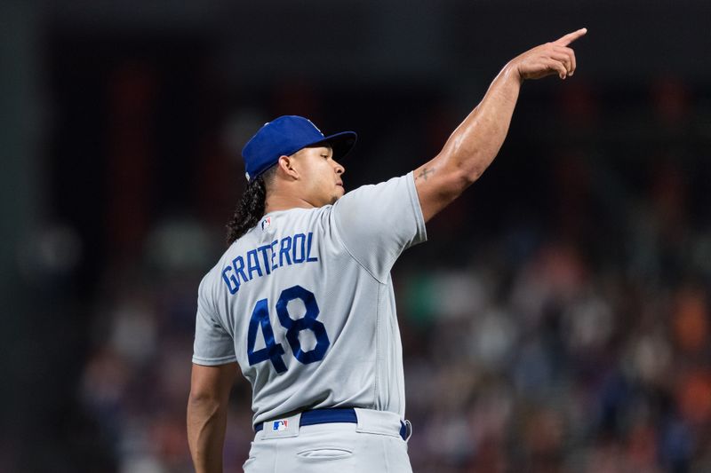 Sep 29, 2023; San Francisco, California, USA; Los Angeles Dodgers relief pitcher Brusdar Graterol (48) celebrates the team   s 6-2 win over the San Francisco Giants at Oracle Park. Mandatory Credit: John Hefti-USA TODAY Sports