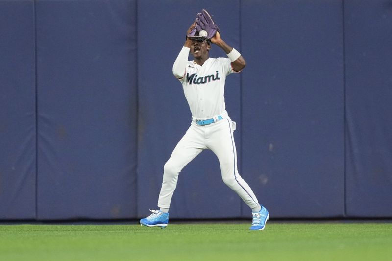 Aug 29, 2023; Miami, Florida, USA;  Miami Marlins center fielder Jazz Chisholm Jr. (2) catches a fly ball off the bat of Tampa Bay Rays second baseman Brandon Lowe (8) in the sixth inning at loanDepot Park. Mandatory Credit: Jim Rassol-USA TODAY Sports