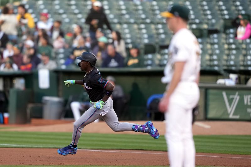 May 3, 2024; Oakland, California, USA; Miami Marlins center fielder Jazz Chisholm Jr. (2) rounds first base after hitting a triple against Oakland Athletics starting pitcher JP Sears (38) during the second inning at Oakland-Alameda County Coliseum. Mandatory Credit: Darren Yamashita-USA TODAY Sports