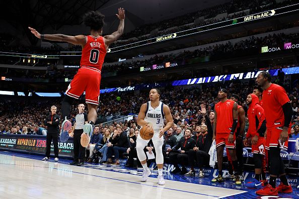 DALLAS, TEXAS - NOVEMBER 01: Grant Williams #3 of the Dallas Mavericks shoots the ball against Coby White #0 of the Chicago Bulls in the first half at American Airlines Center on November 01, 2023 in Dallas, Texas. NOTE TO USER: User expressly acknowledges and agrees that, by downloading and or using this photograph, User is consenting to the terms and conditions of the Getty Images License Agreement. (Photo by Tim Heitman/Getty Images)