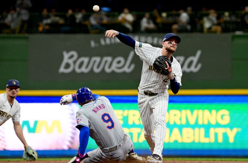 Oct 2, 2024; Milwaukee, Wisconsin, USA; Milwaukee Brewers second baseman Brice Turang (2) throws to first during the first inning in game two of the Wildcard round for the 2024 MLB Playoffs against the New York Mets at American Family Field. Mandatory Credit: Benny Sieu-Imagn Images