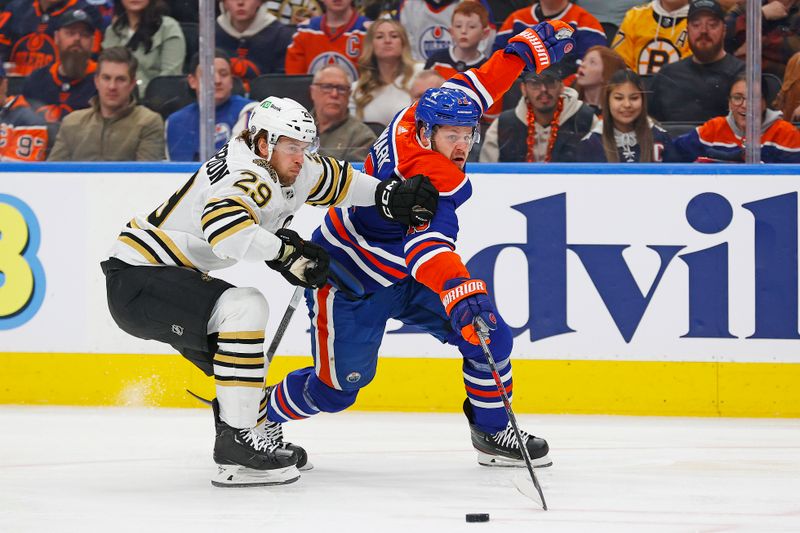 Feb 21, 2024; Edmonton, Alberta, CAN; Edmonton Oilers forward Mattias Janmark (13) and Boston Bruins defensemen Parker Wotherspoon (29) chase a loose puck during the first period at Rogers Place. Mandatory Credit: Perry Nelson-USA TODAY Sports