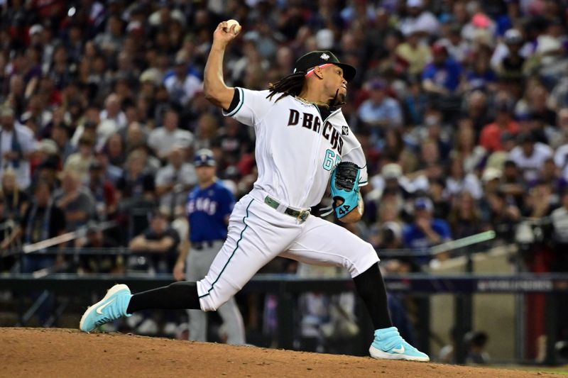 Oct 30, 2023; Phoenix, Arizona, USA; Arizona Diamondbacks relief pitcher Luis Frias (65) pitches in the eighth inning against the Texas Rangers in game three of the 2023 World Series at Chase Field. Mandatory Credit: Matt Kartozian-USA TODAY Sports