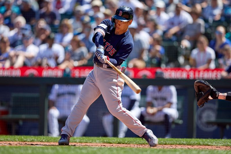 Aug 2, 2023; Seattle, Washington, USA; Boston Red Sox player Masataka Yoshida hits an RBI single during the fifth inning at T-Mobile Park. Mandatory Credit: John Froschauer-USA TODAY Sports