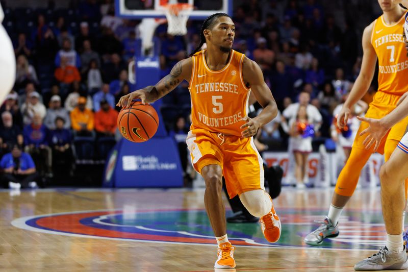 Jan 7, 2025; Gainesville, Florida, USA; Tennessee Volunteers guard Zakai Zeigler (5) dribbles the ball against the Florida Gators during the first half at Exactech Arena at the Stephen C. O'Connell Center. Mandatory Credit: Matt Pendleton-Imagn Images