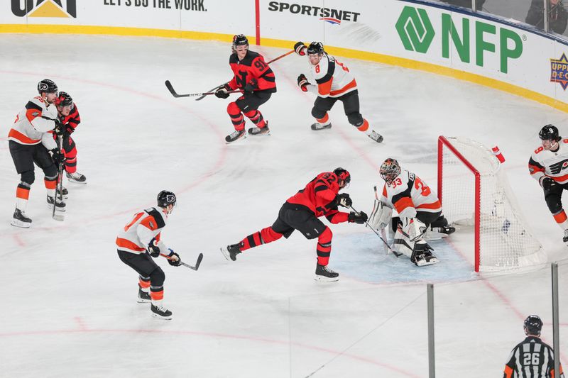 Feb 17, 2024; East Rutherford, New Jersey, USA; Philadelphia Flyers goaltender Samuel Ersson (33) makes a save against New Jersey Devils left wing Tomas Nosek (92) during the third period in a Stadium Series ice hockey game at MetLife Stadium. Mandatory Credit: Vincent Carchietta-USA TODAY Sports