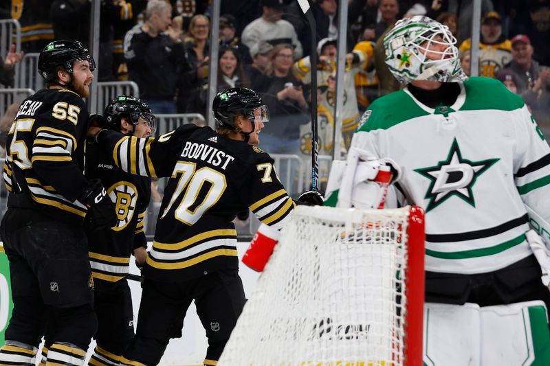 Feb 19, 2024; Boston, Massachusetts, USA; Boston Bruins center Jesper Boqvist (70) celebrates his goal with right wing Justin Brazeau (55) and center Anthony Richard (90) as Dallas Stars goaltender Jake Ottinger (29) watches the replay during the first period at TD Garden. Mandatory Credit: Winslow Townson-USA TODAY Sports